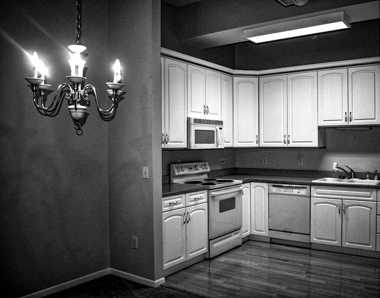 Kitchen with chandelier in condo