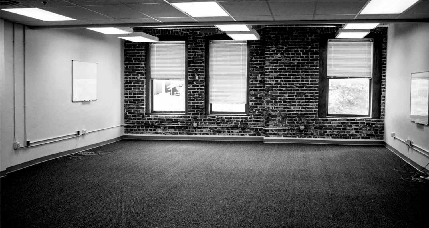 Open office space exposed brick wall with large O street facing windows